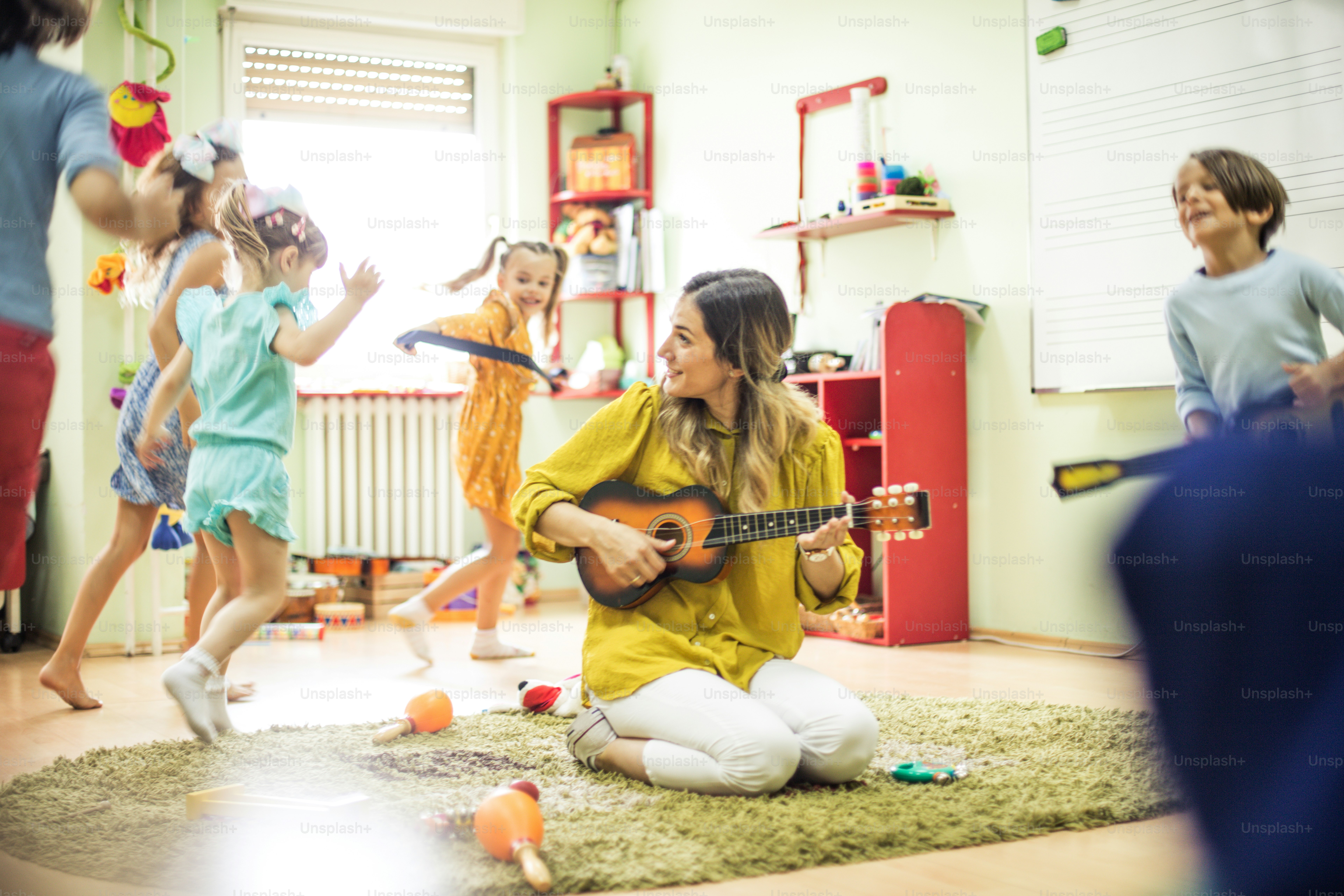 Moment of happiness. Children with teacher in preschool.