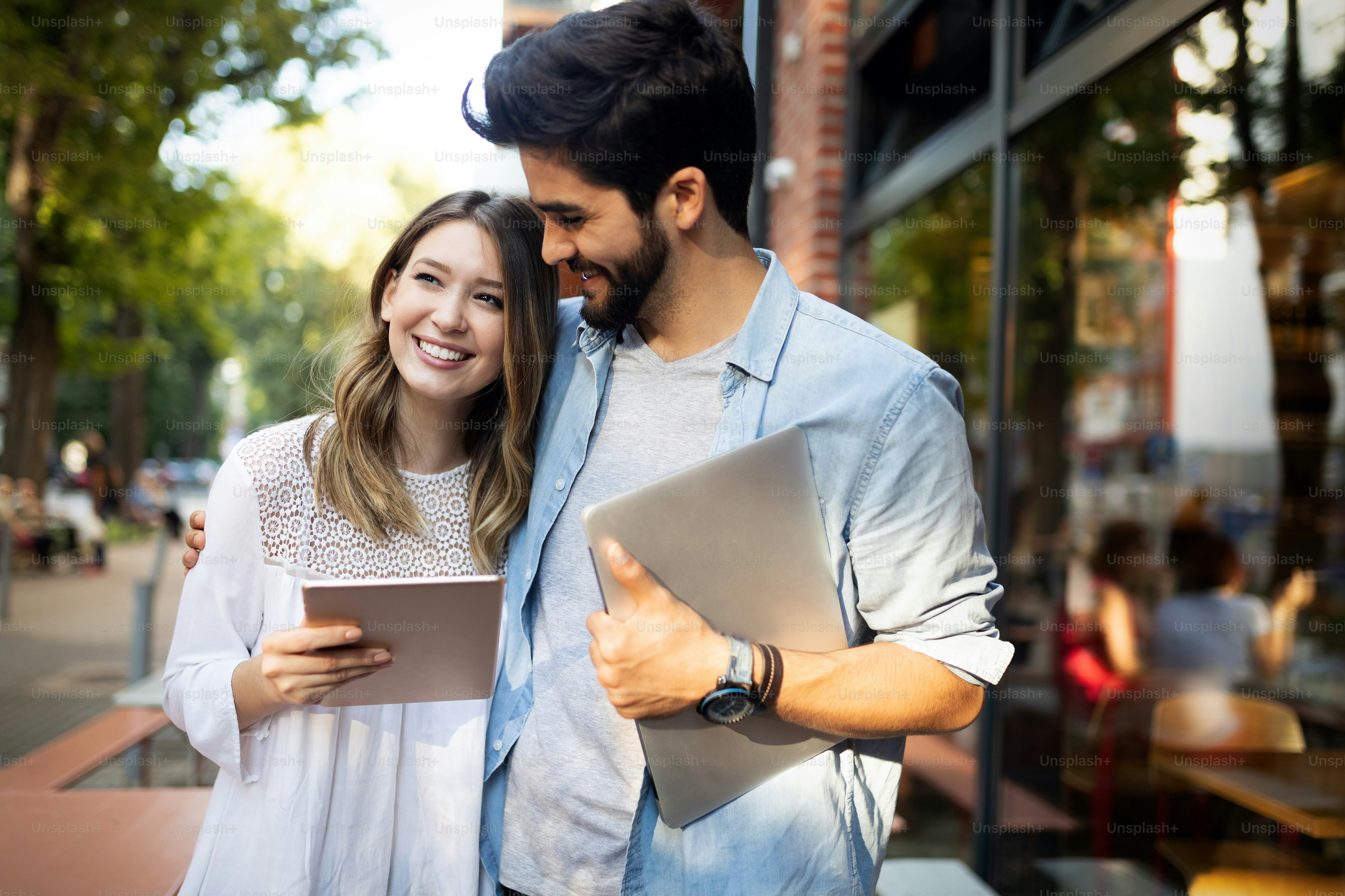 Happy young couple using a digital tablet together and smiling