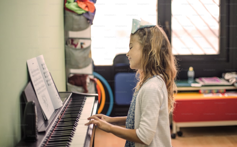 The piano plays with pleasure. Little girl playing piano.