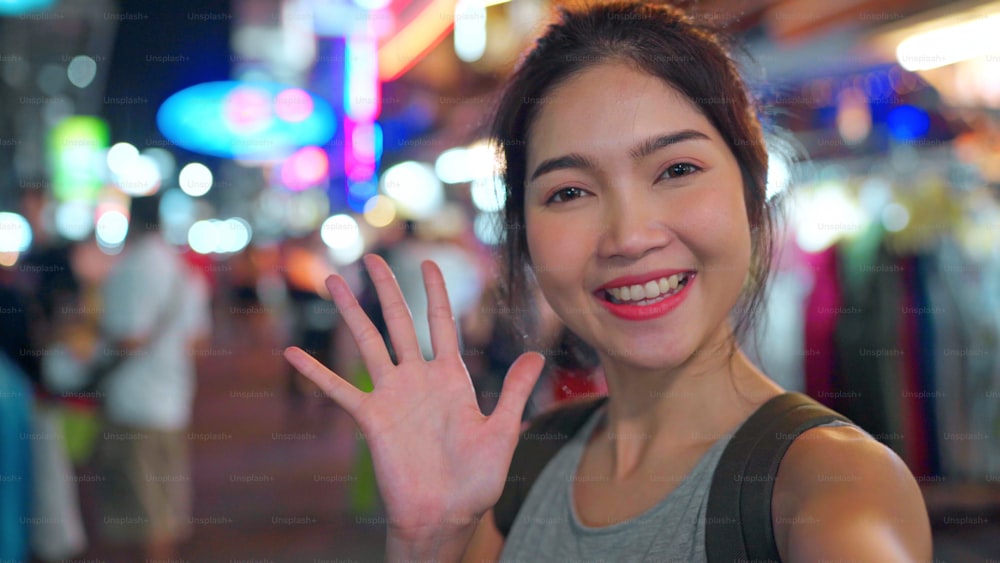 Donna blogger asiatica viaggiatrice a Bangkok, Thailandia, bella femmina che usa il telefono cellulare crea vlog e vive nei social media durante il ritrovo a The Khao San Road. Le donne viaggiano in Thailandia concetto.