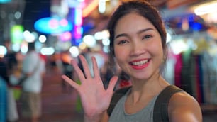 Traveler Asian blogger woman travel in Bangkok, Thailand, beautiful female using mobile phone make vlog and live in social media while hangout at The Khao San Road. Women travel in Thailand concept.
