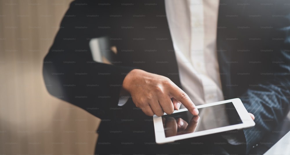 Cropped view of young businessman searching for the information for the next project