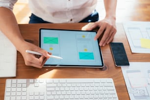 Web designer, UX UI designer designing mobile application user interface. Creative planning application development sketch layout wireframe design.