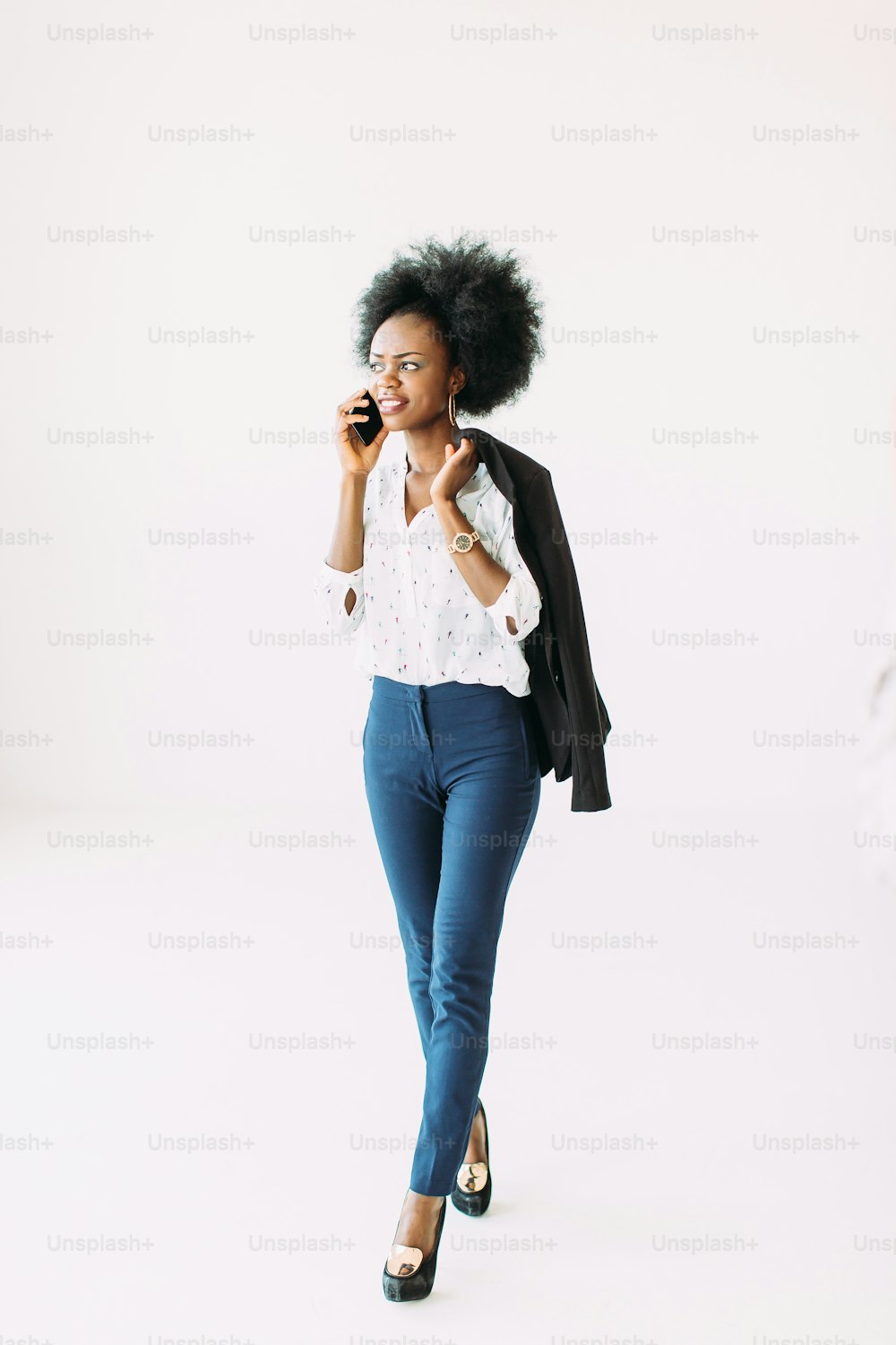 Smiling young afro american business woman using cell phone.