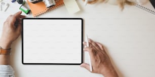 Top view of male photographer working on  his project with blank screen tablet