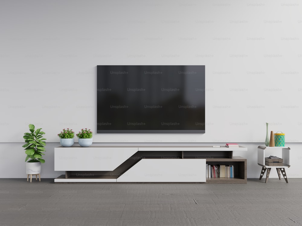 TV en el gabinete en la sala de estar moderna con planta en fondo de pared blanca, renderizado 3d