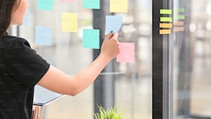 Sticky note paper reminder young woman share idea on sticky note. Discussing - business.