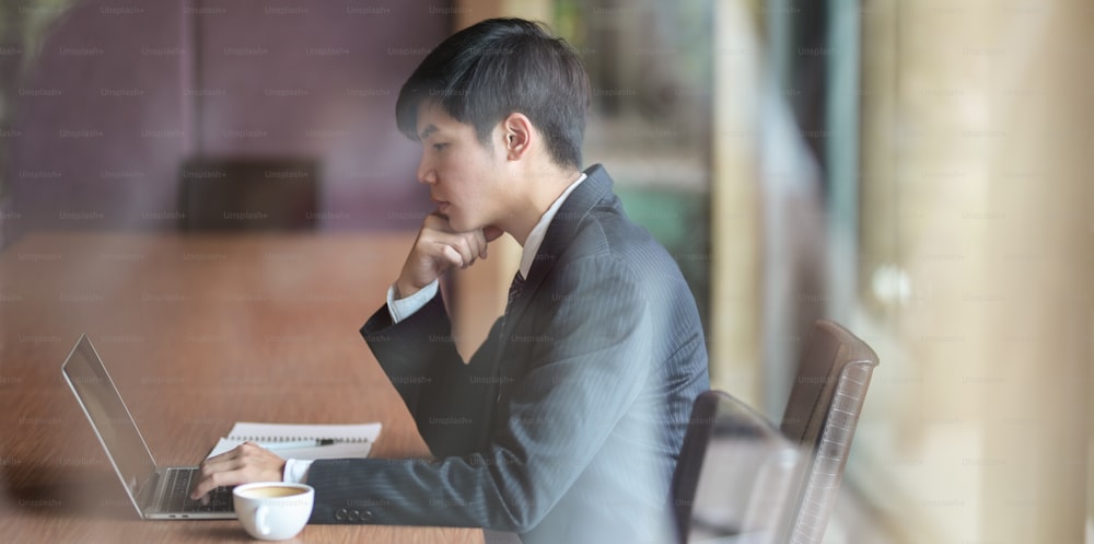 Young businessman looking stressful while working on project with laptop computer