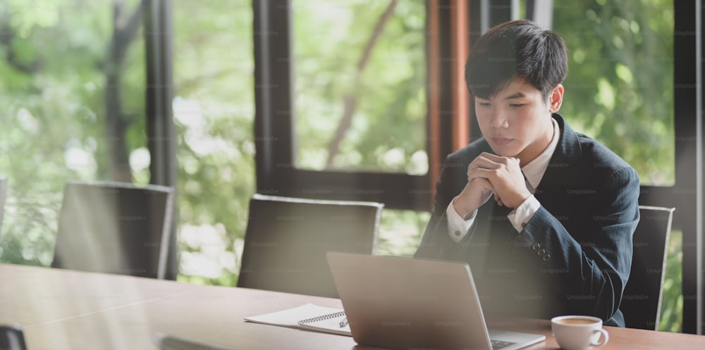 Young businessman looking stressful while working on project with laptop computer