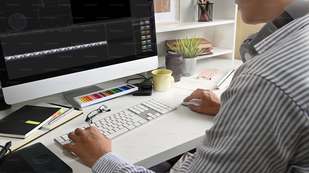 Confident man editing footage on creative workplace.