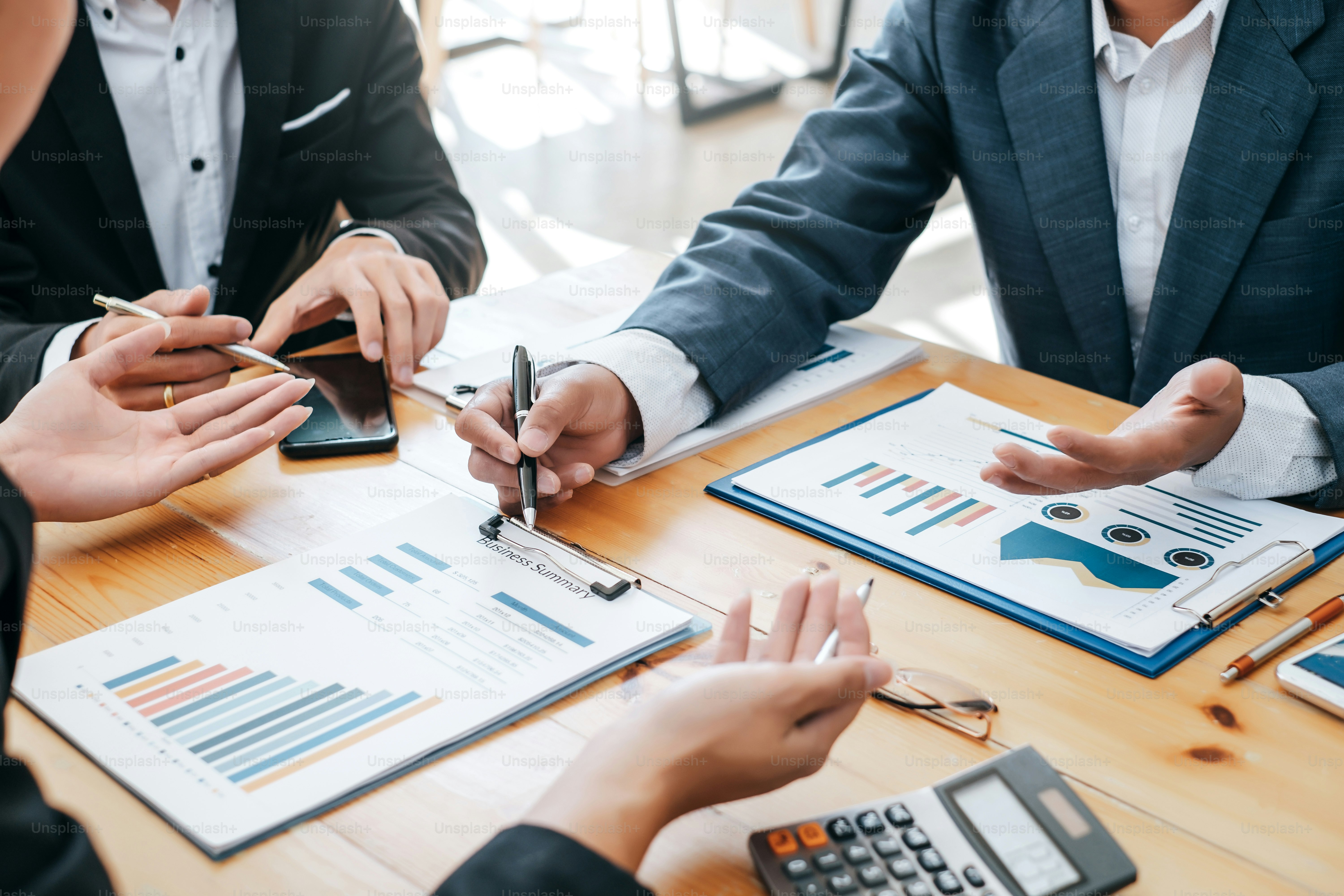 Business team discussing investment charts