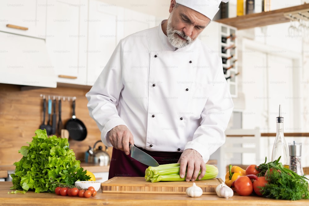 Chef cutting fresh and delicious vegetables for cooking