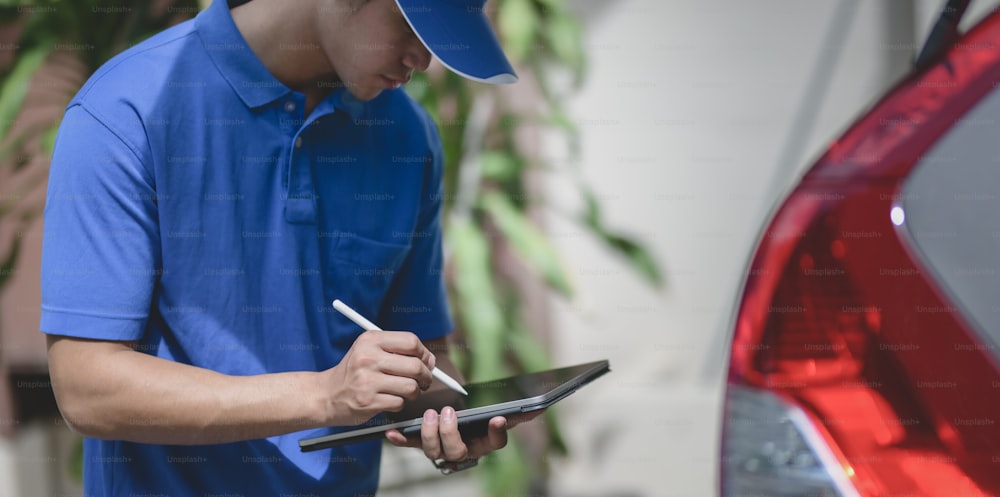 Delivery man checking orders on tablet,"npreparing the products to customers