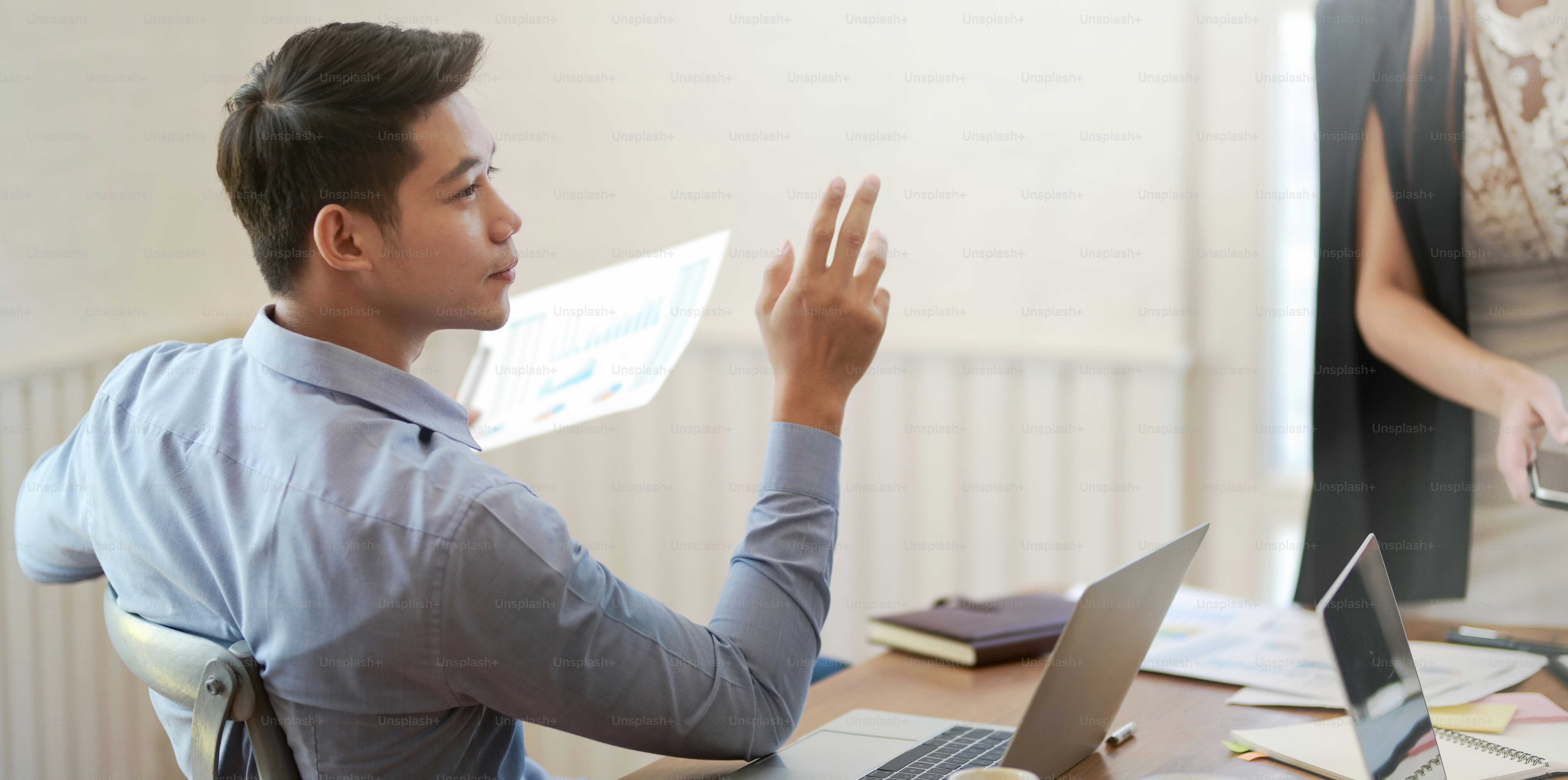 Young professional businessman discussing the ideas with his female coworker