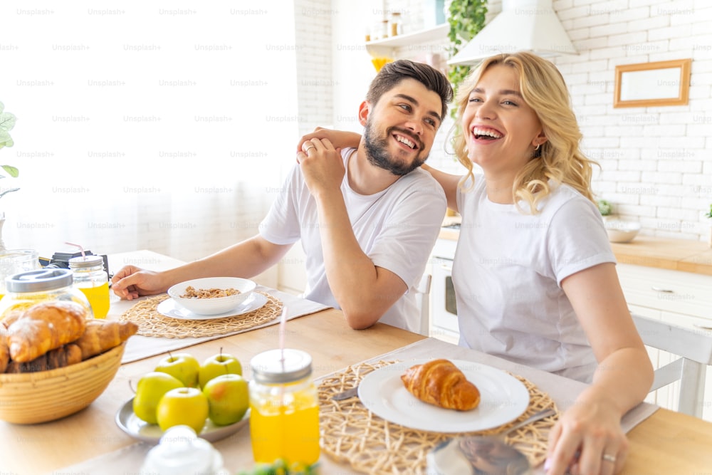 Smiling young man and woman on the kitchen stock photo