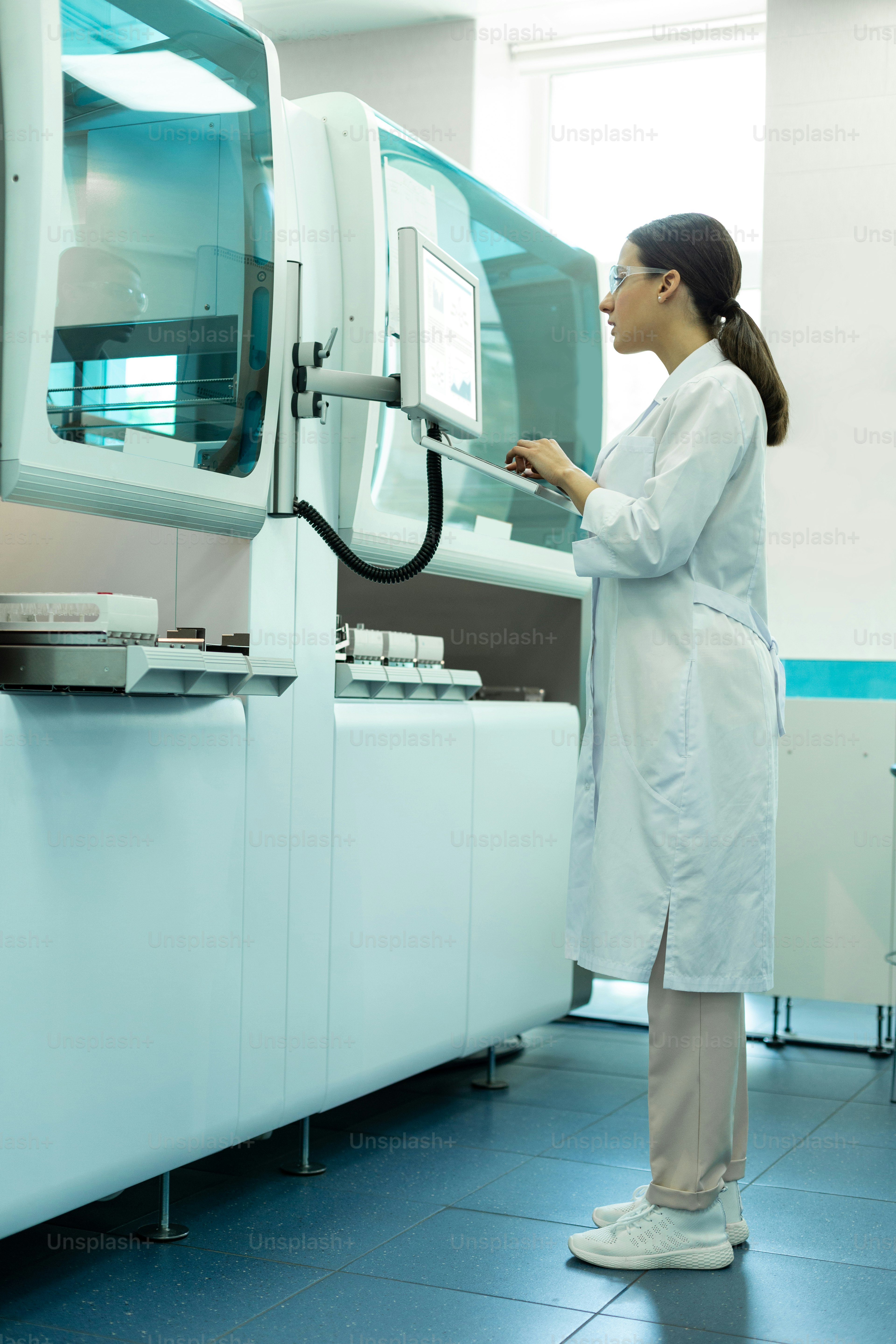 Health and medicine. Attentive young scientist wearing uniform while ...