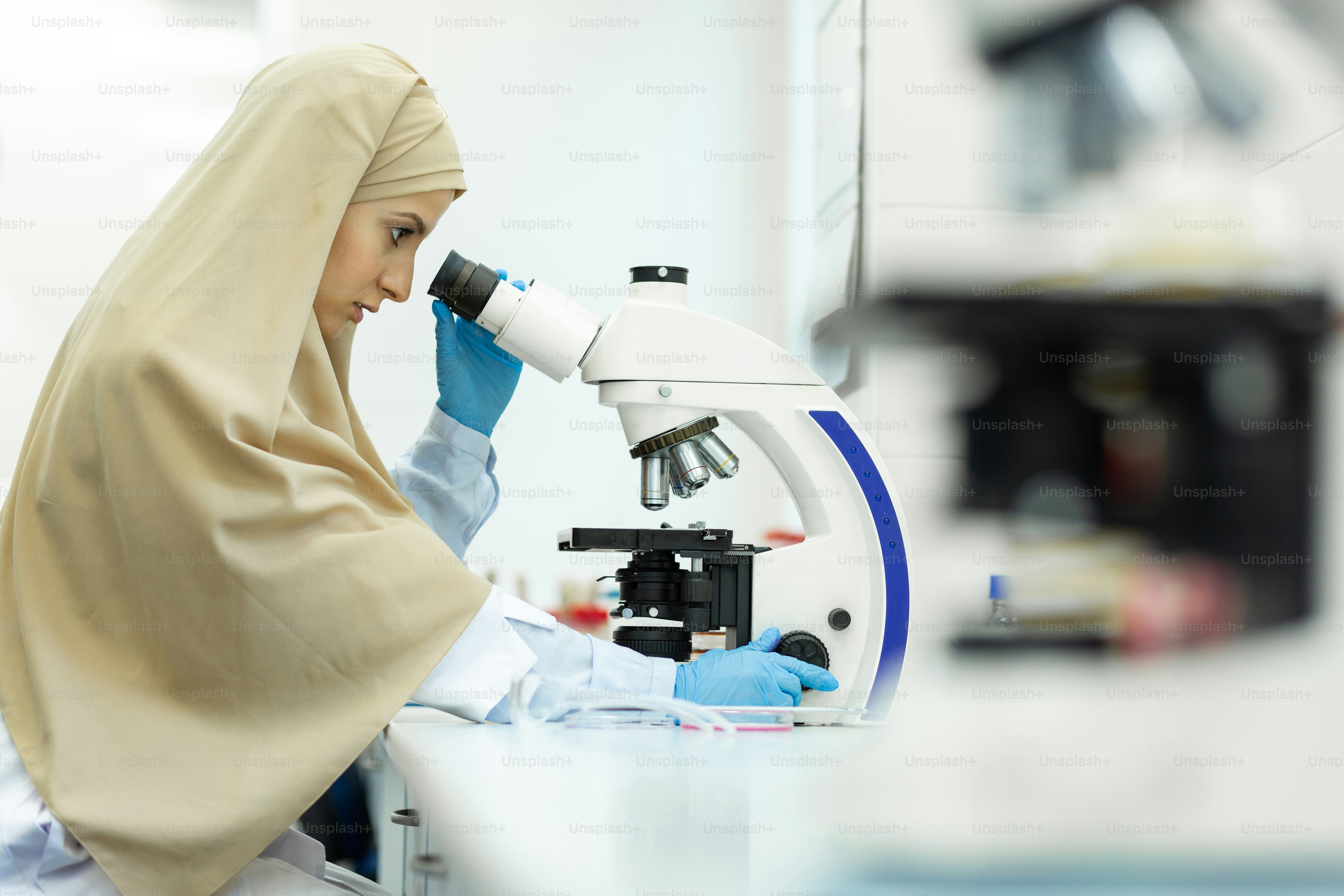 Young worker. Delighted woman looking downwards while doing DNA ...