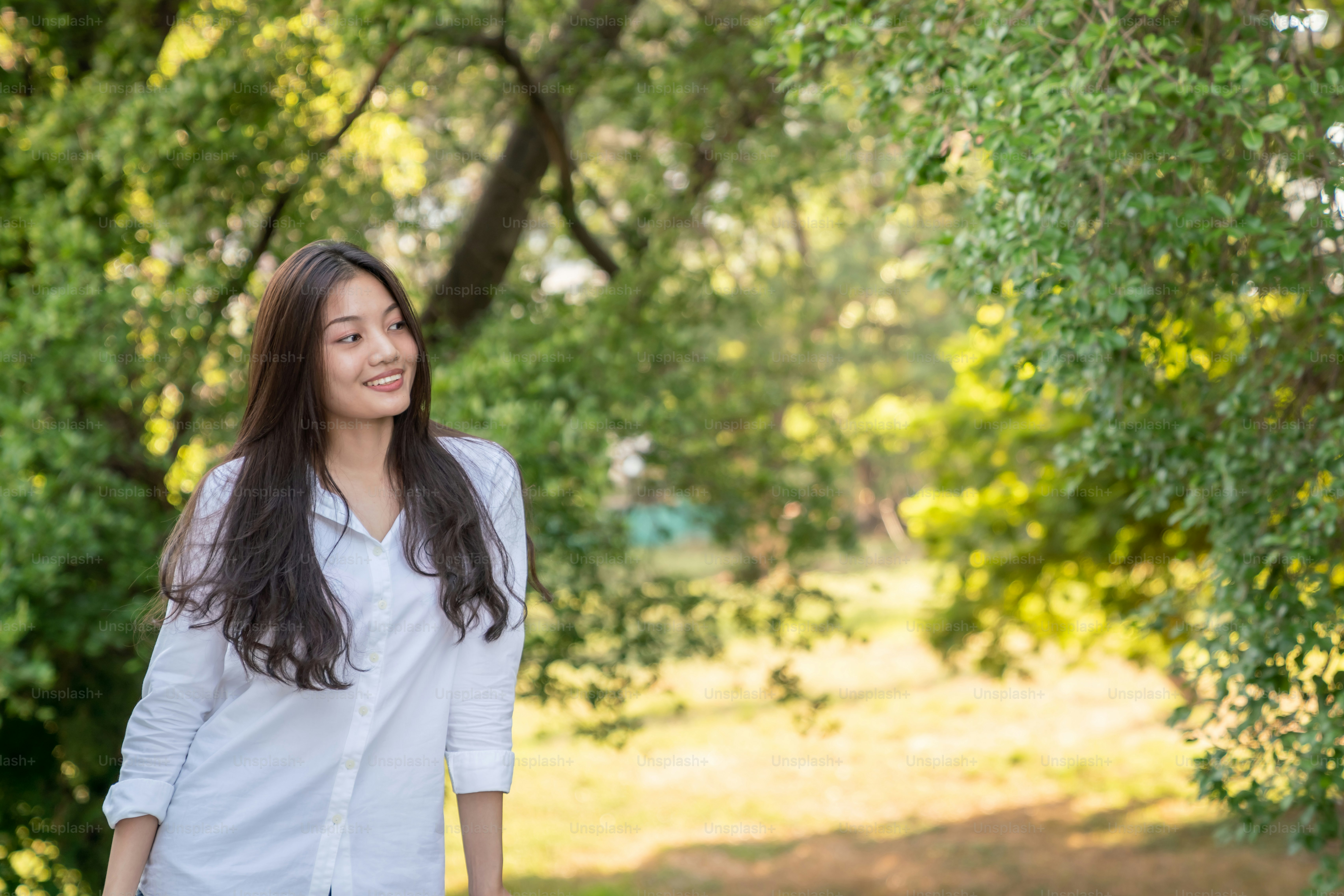 Young asian woman standing on balcony on home balcony in the morning