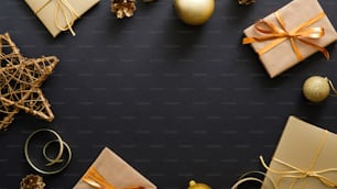Christmas banner. Black Xmas background with golden decorations, gifts box, balls, star. Christmas poster, greeting card template, website header banner mockup. Flat lay, top view, copy space