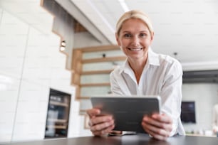 Pretty woman with digital tablet stock photo