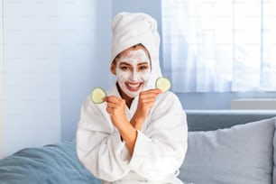 Natural homemade fresh cucumber facial eye pads facial masks. Woman holding cucumber pads and smile relax with natural homemade. A picture of a face of a beautiful woman posing with a cucumber