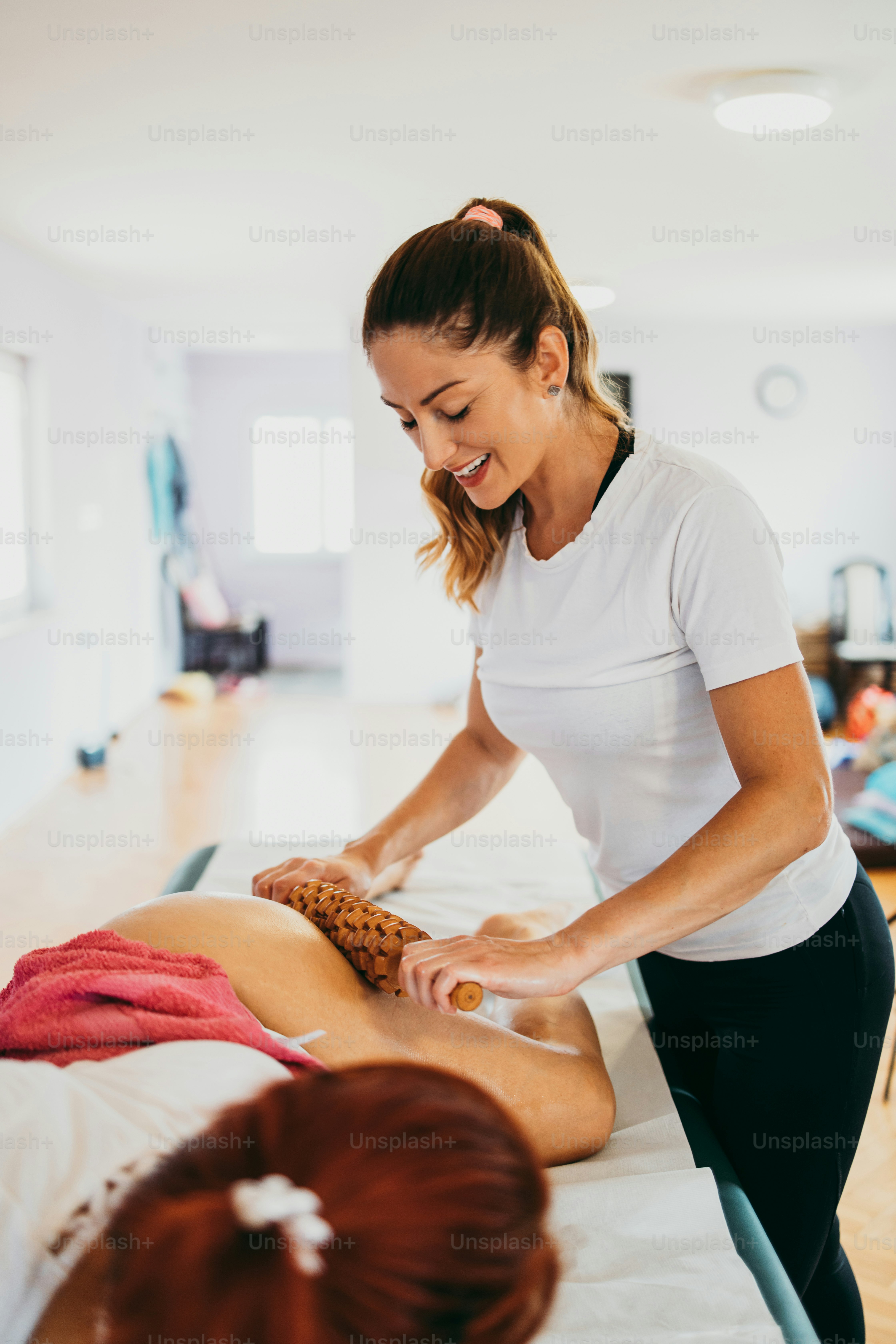 Middle age woman at professional anti cellulite maderotherapy massage treatment. Close up shot.