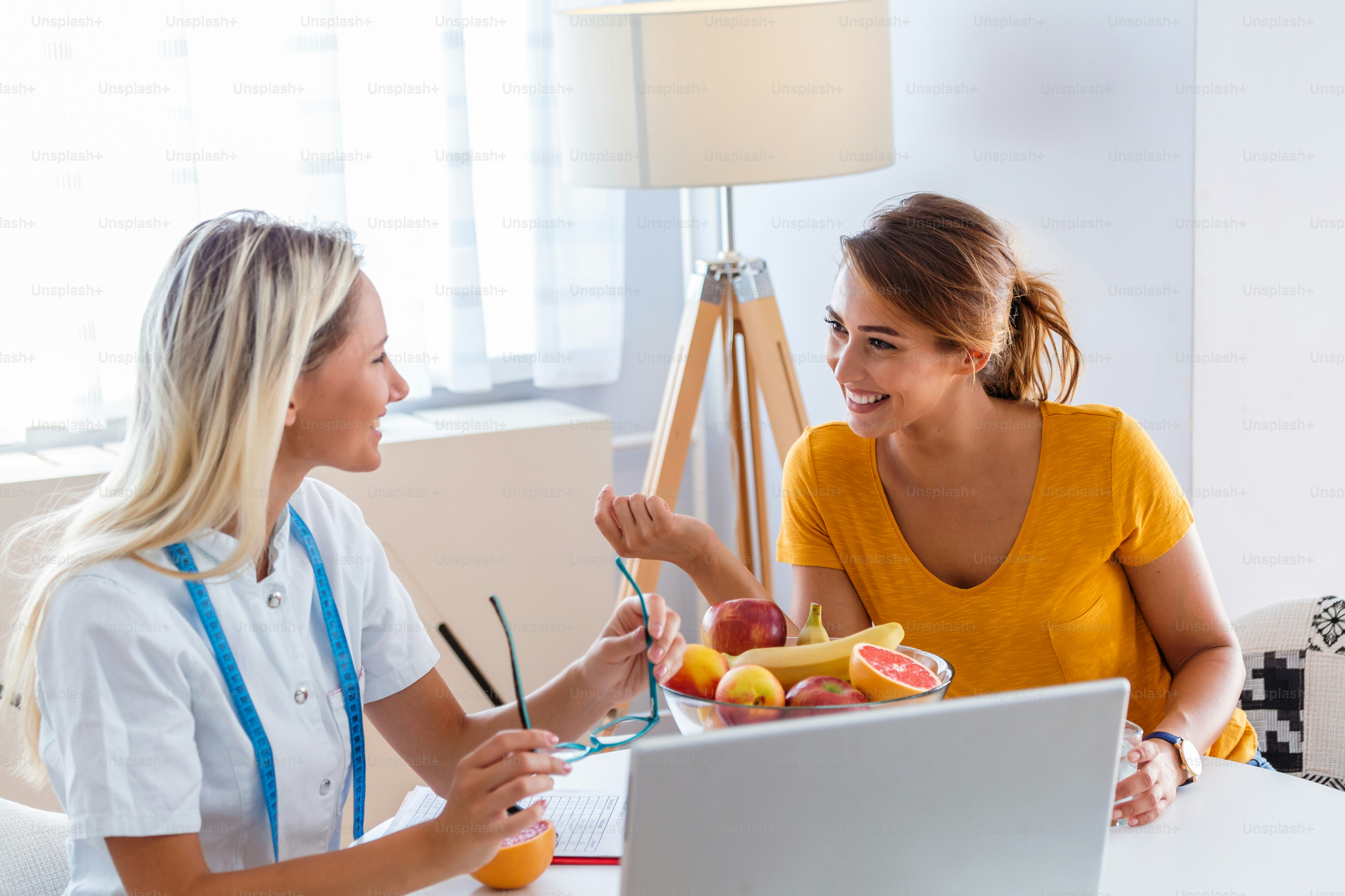 Doctor nutritionist, dietician and female patient on consultation in the office. Female nutritionist giving consultation to patient. Making diet plan.