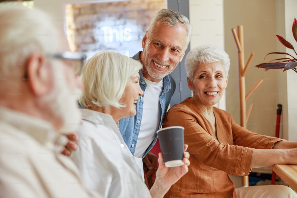 Group of senior people chatting and laughing stock photo