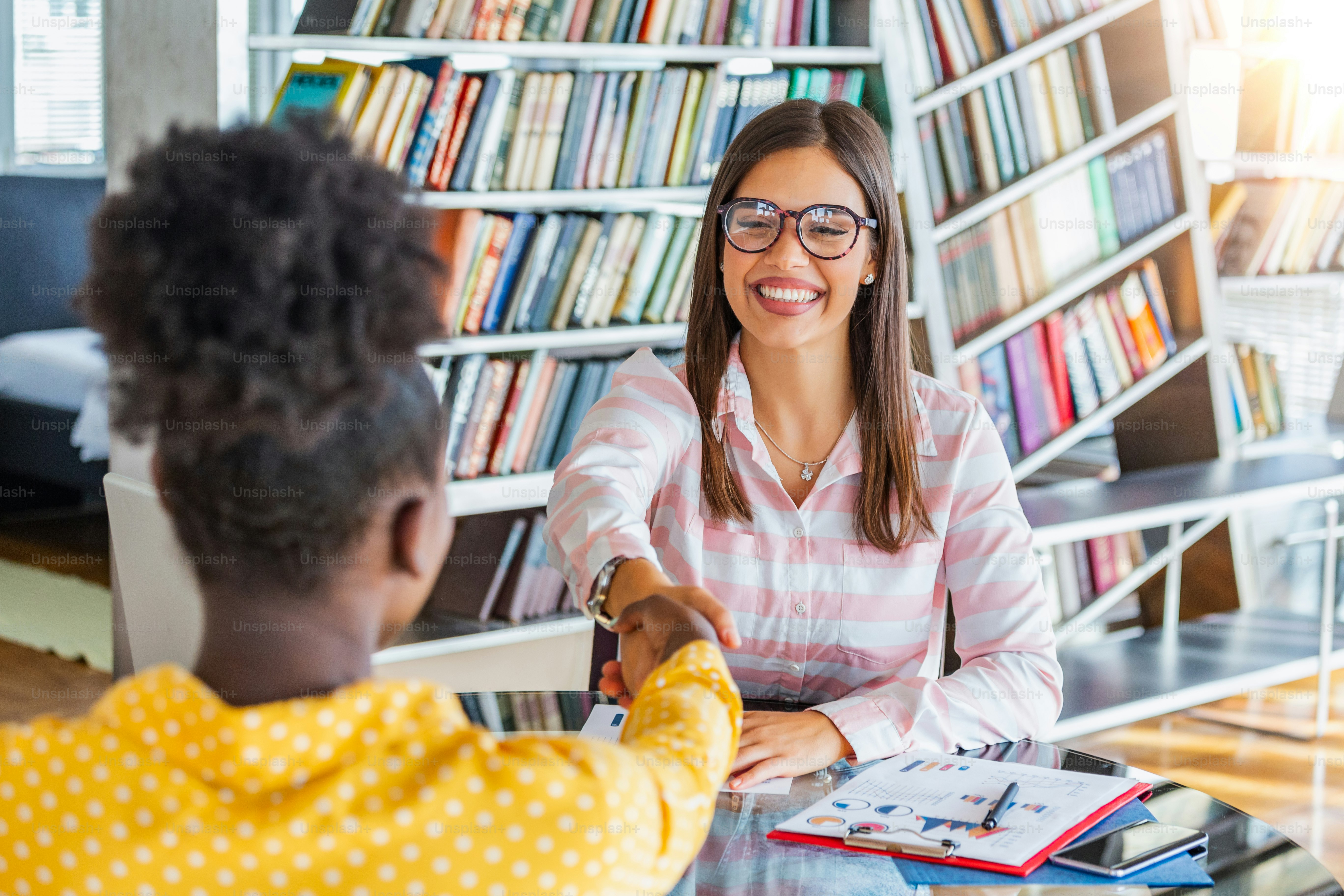 Business people shaking hands, finishing up a meeting. Corporate business team work office meeting. Two businesswoman talking strategy together. Success concept handshake contract deal.