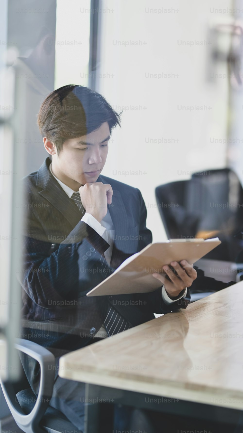 Male lawyer working on a laptop and providing legal document for his client