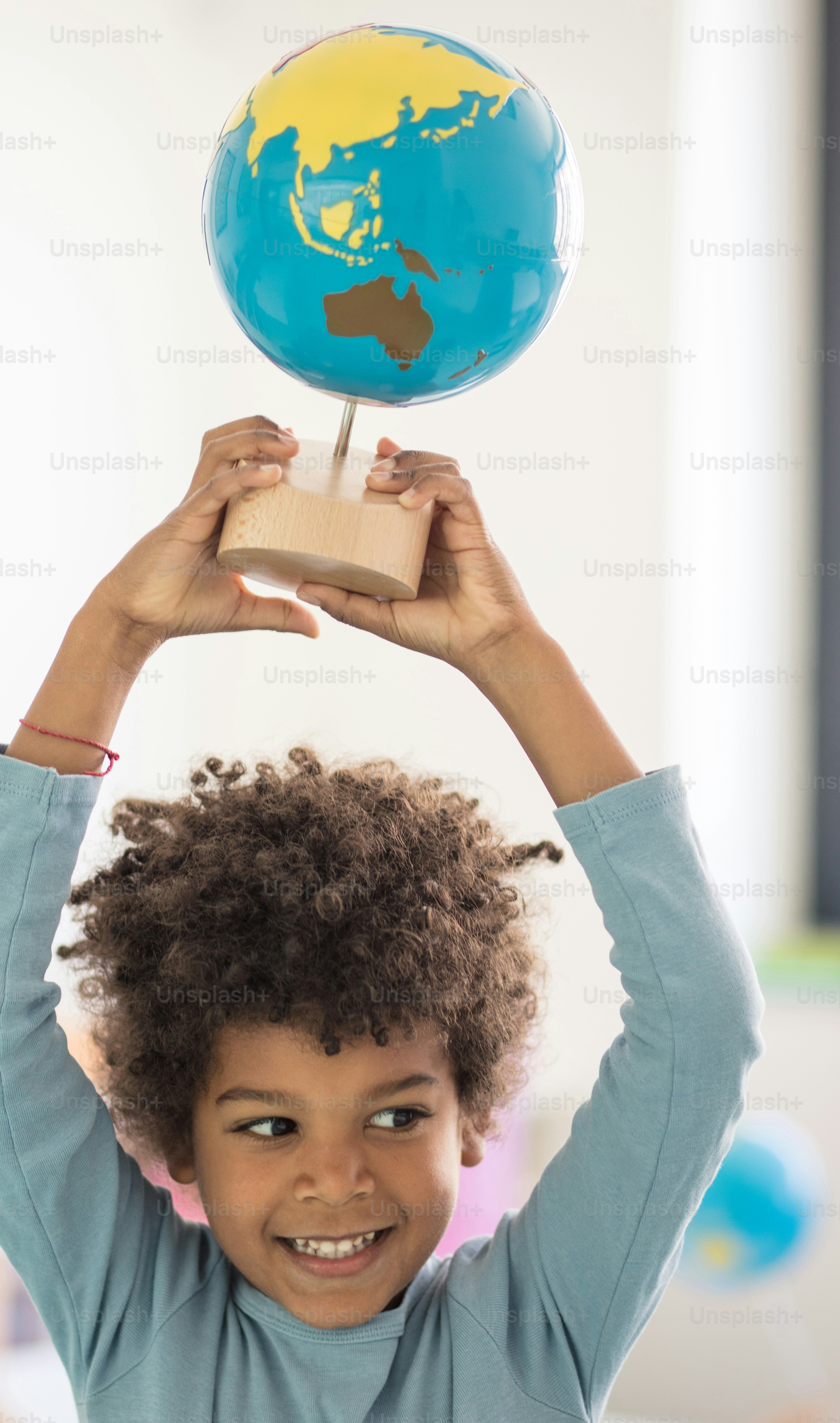 The world is in my hands. Child in preschool.