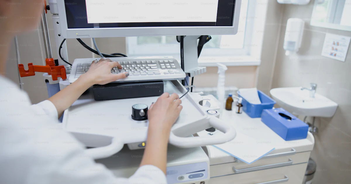 Clinic Computer Setting Female is working with modern digital equipment in clinic and typing ...