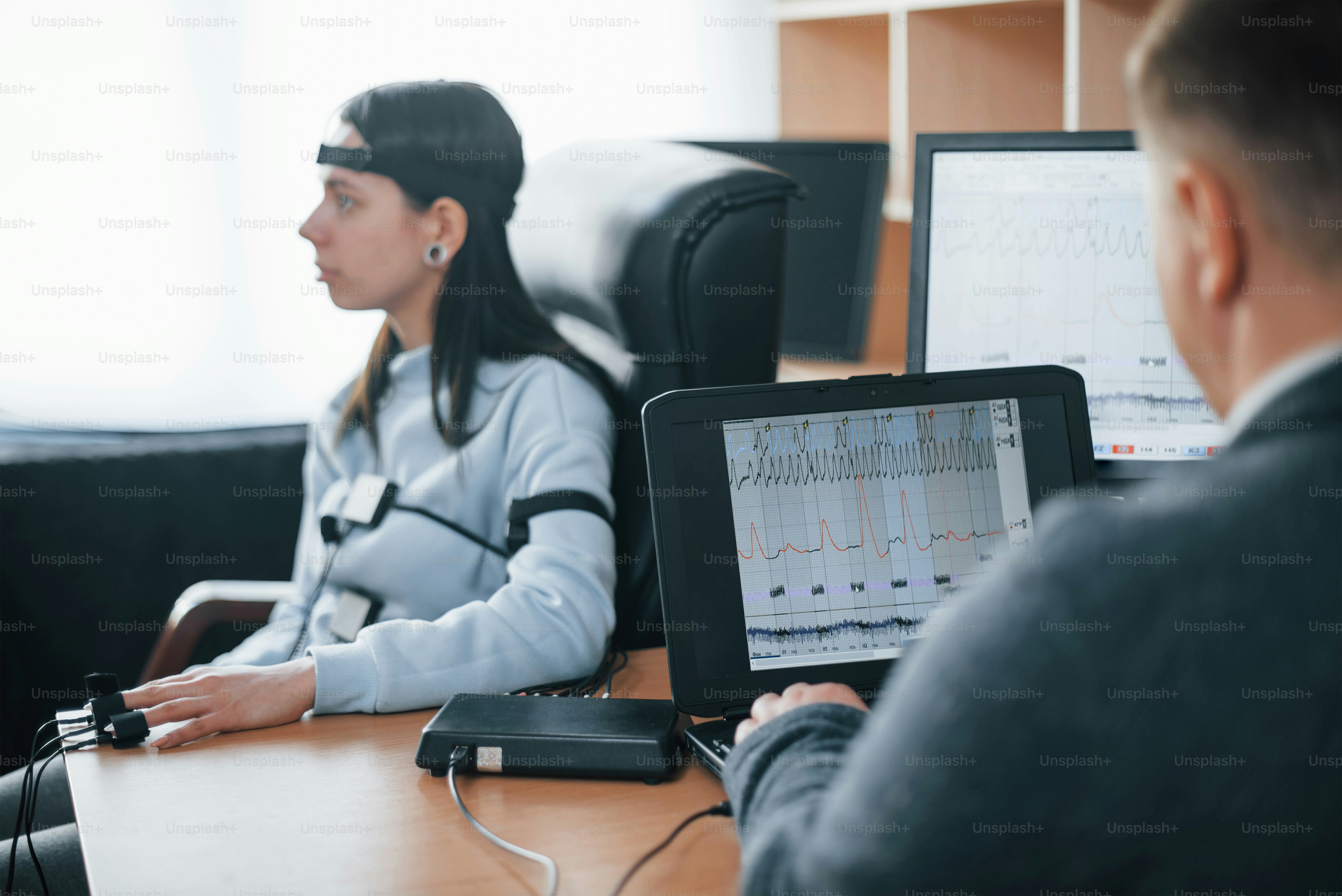 Girl passes lie detector in the office. Asking questions. Polygraph test.