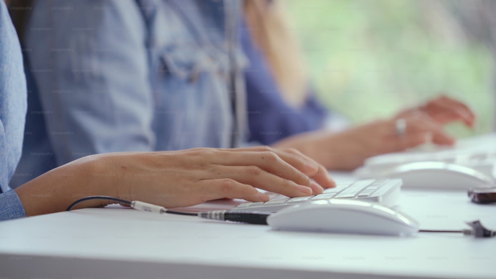 Close up shot of businesswoman hand typing and working on desktop computer on the office desk. Business communication and workplace concept.