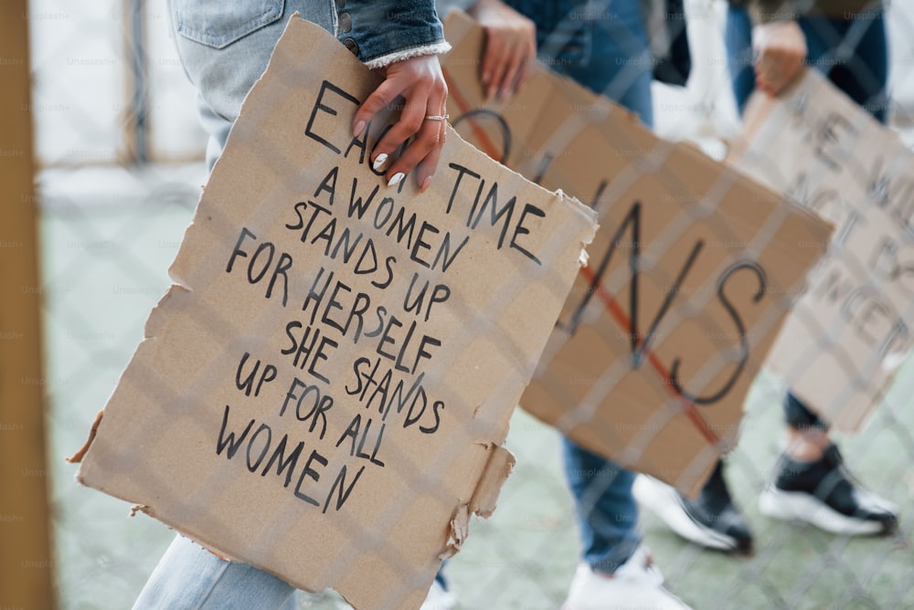 Cropped photo. Group of feminist women have protest for their rights outdoors.