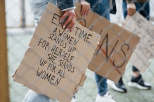 Cropped photo. Group of feminist women have protest for their rights outdoors.