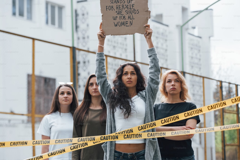 We will stand here until you'll hear us. Group of feminist women have protest for their rights outdoors.