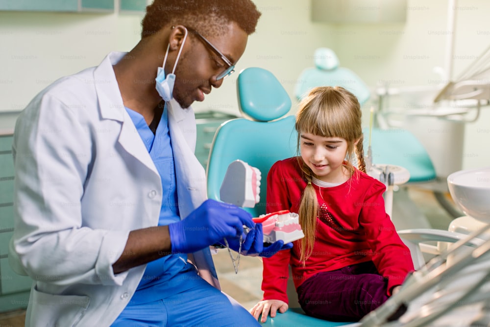 Dentist examines baby girl's teeth.Prophylaxis of caries, milk teeth, pediatrics