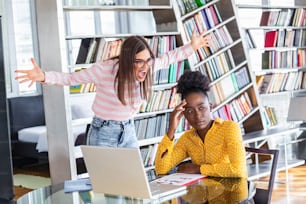 Mobbing at Work. Young ambitious female boss yelling at new unhappy female employee. Disrespect in the Workplace. Angry boss yelling at his young employee