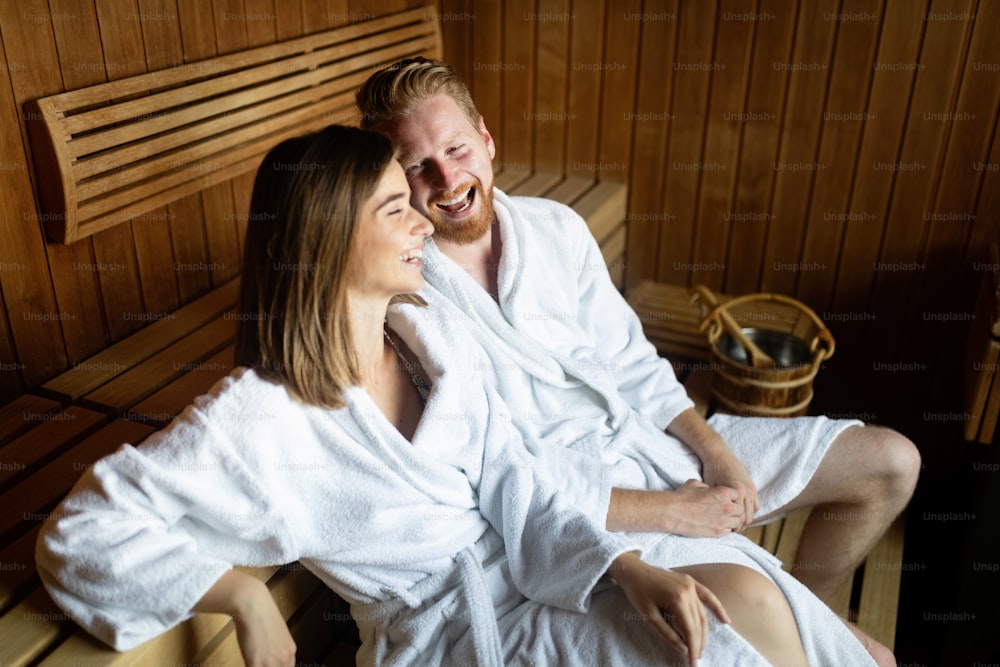 Beautiful young couple relaxing in sauna and caring about health and skin
