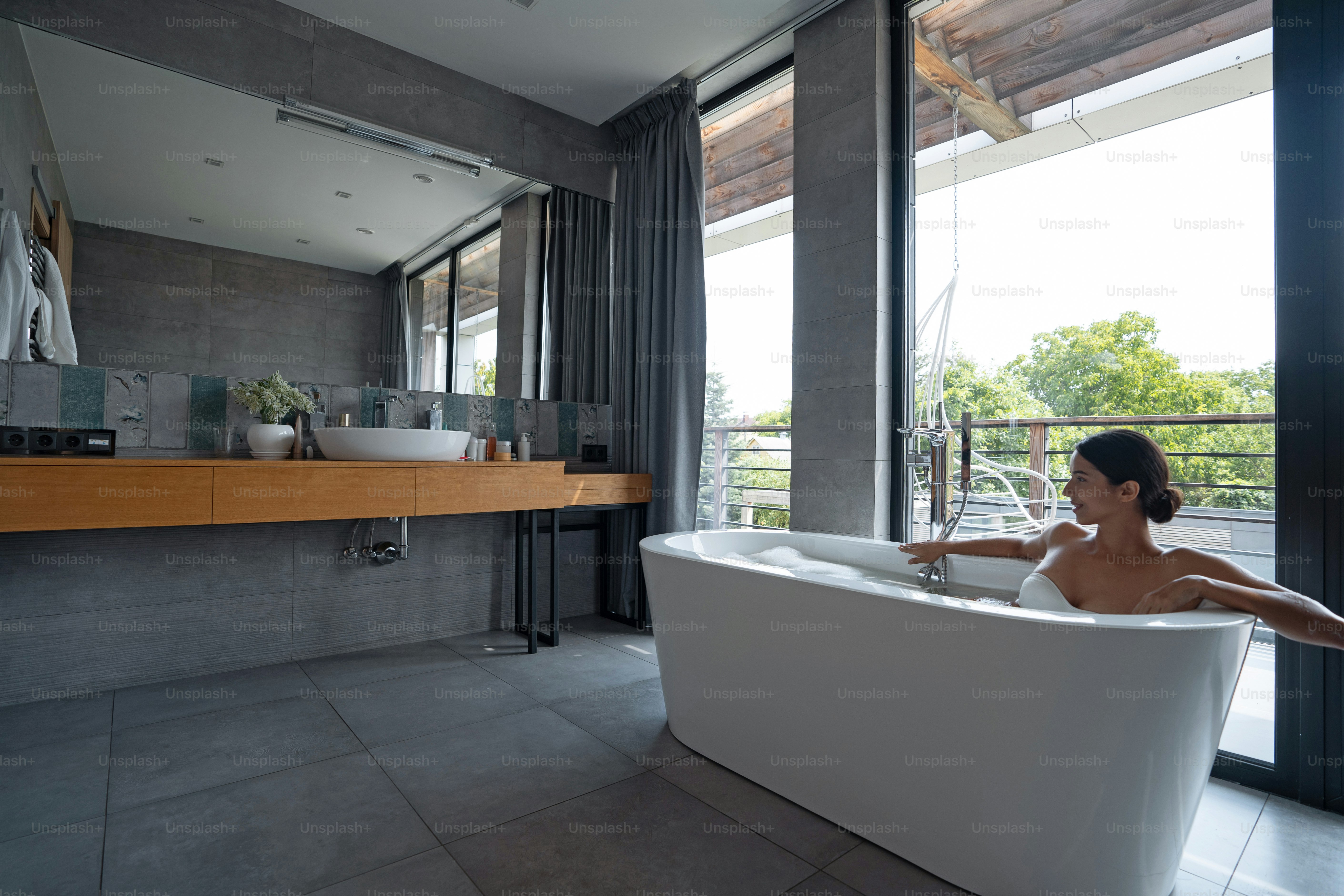 Attractive calm Caucasian young female enjoying a bubble bath