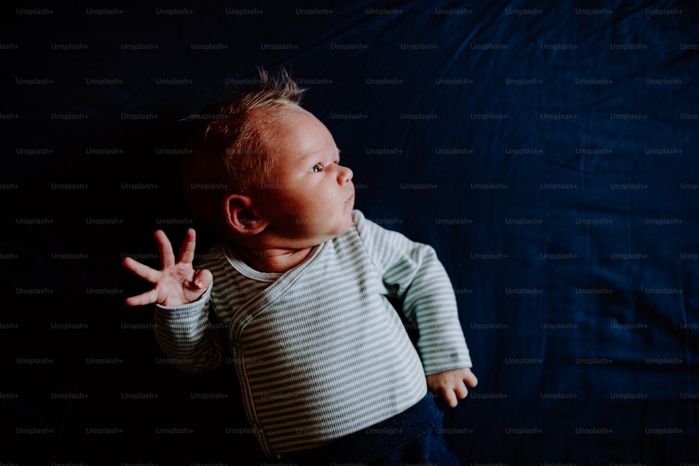 A close-up of a cute newborn baby at home, top view. Copy space.