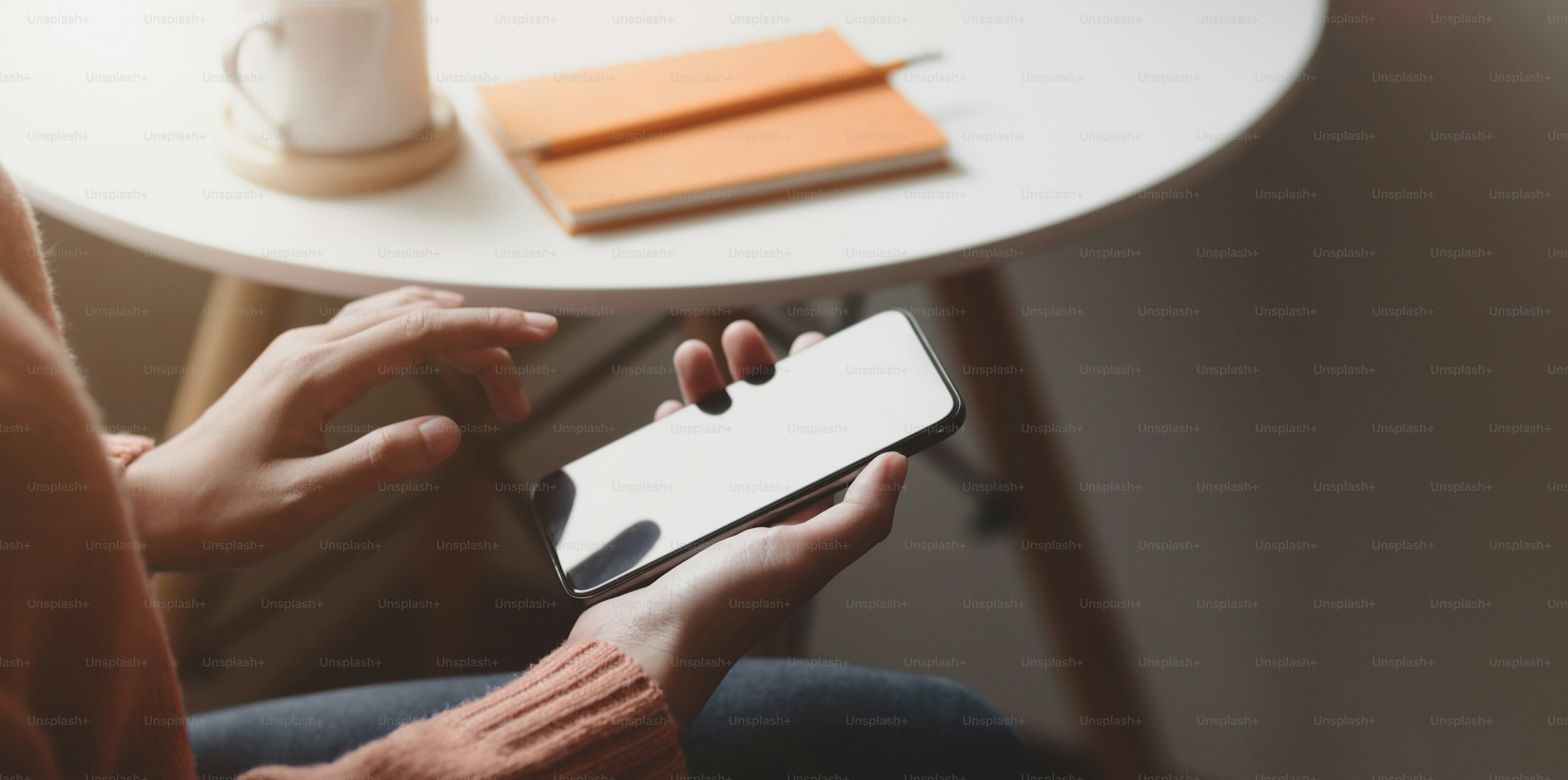 Cropped shot of young female holding smartphone in comfortable ...