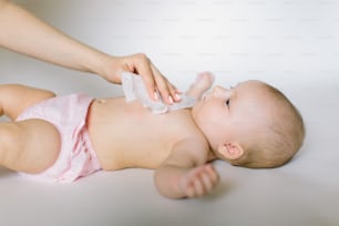 Hygiene - young momy wiping the baby skin with wet wipes. Cleaning wipe, pure, clean.