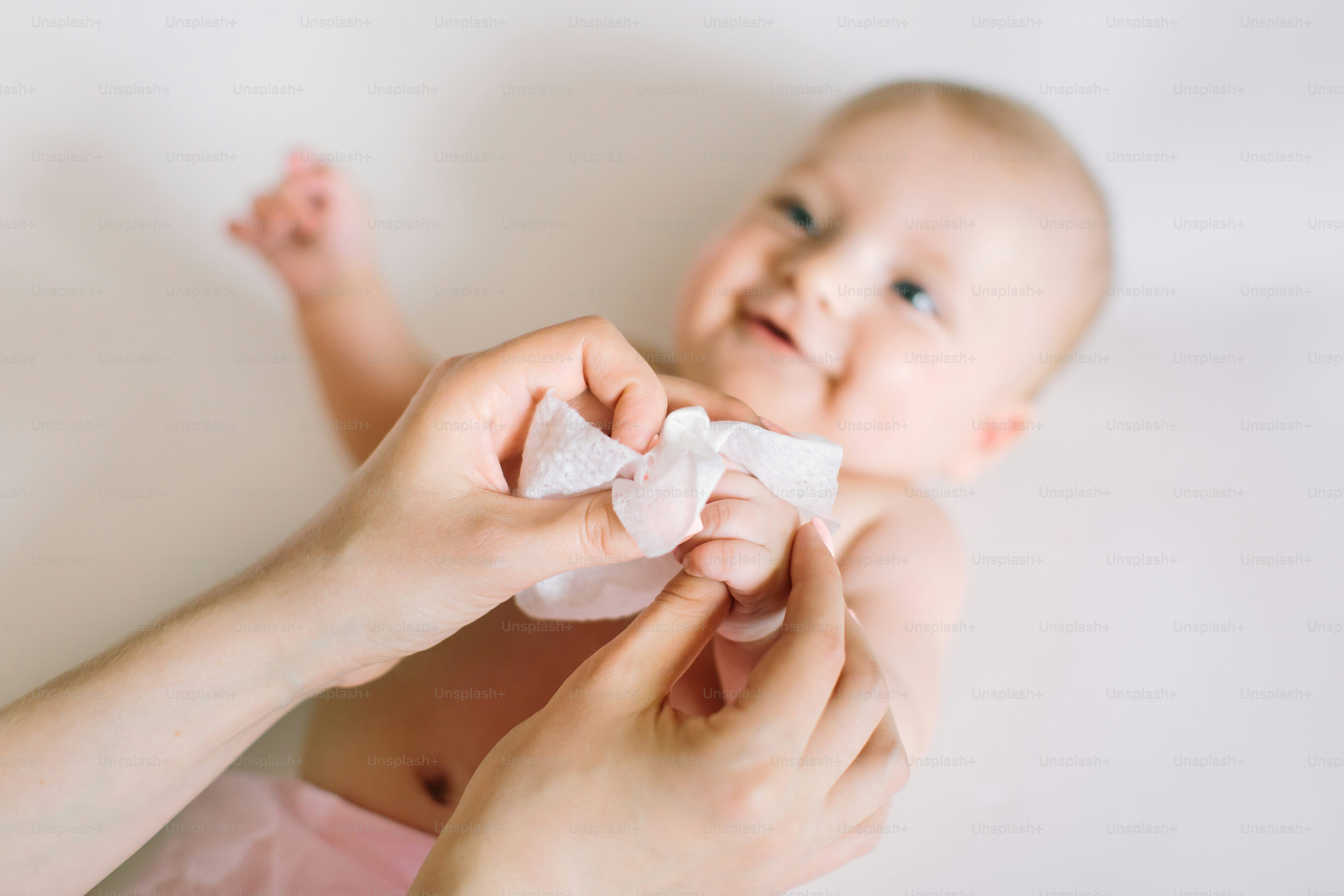 After shower baby wrapped into towels on the diaper table.