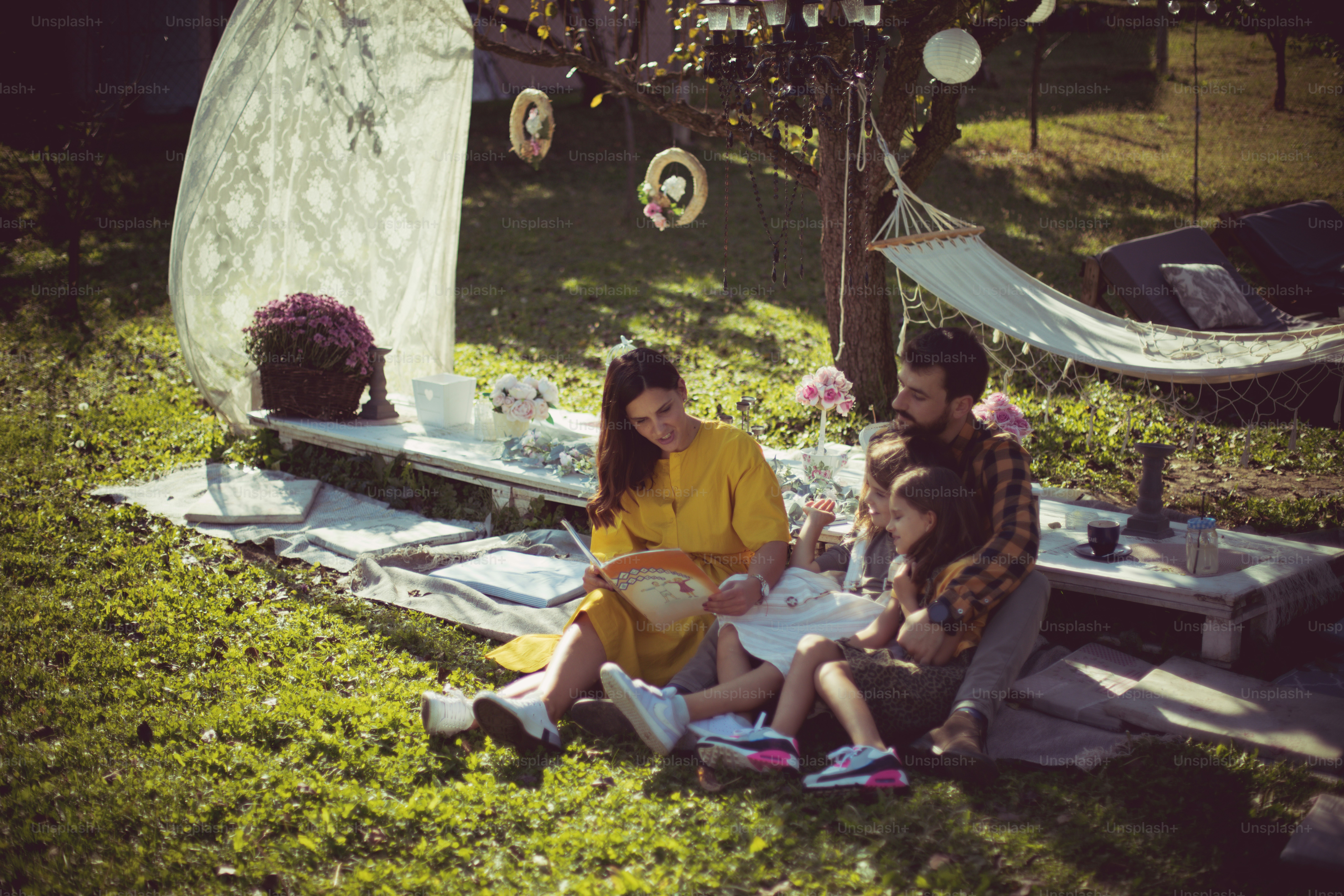 Mom is going to read you a wonderful fairy tale. Family having fun in nature.