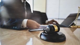 Selective focus Scales and judge gavel with scales businessman lawyer working.