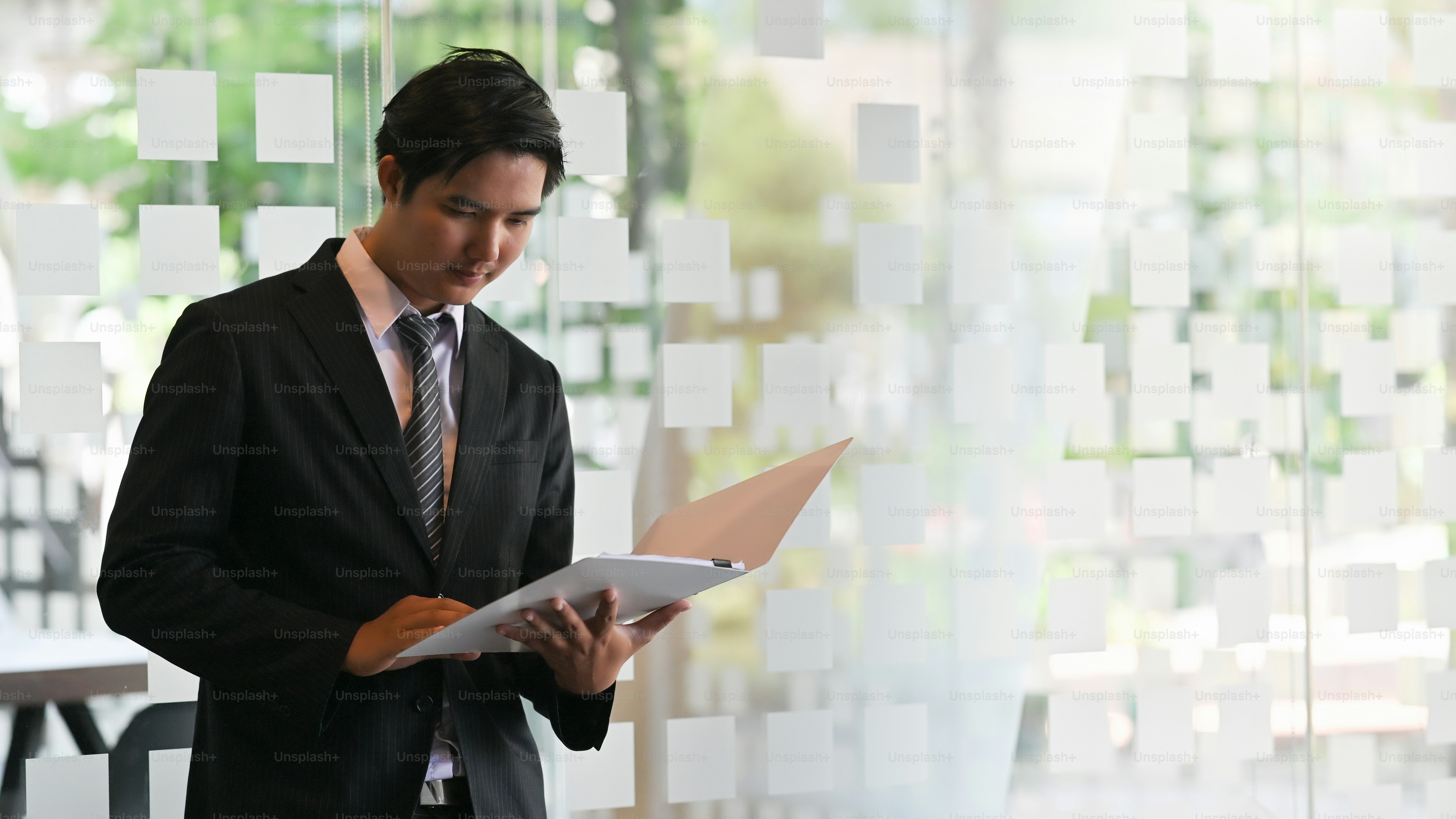 Businessman reading a report document work paper. photo – Thailand ...