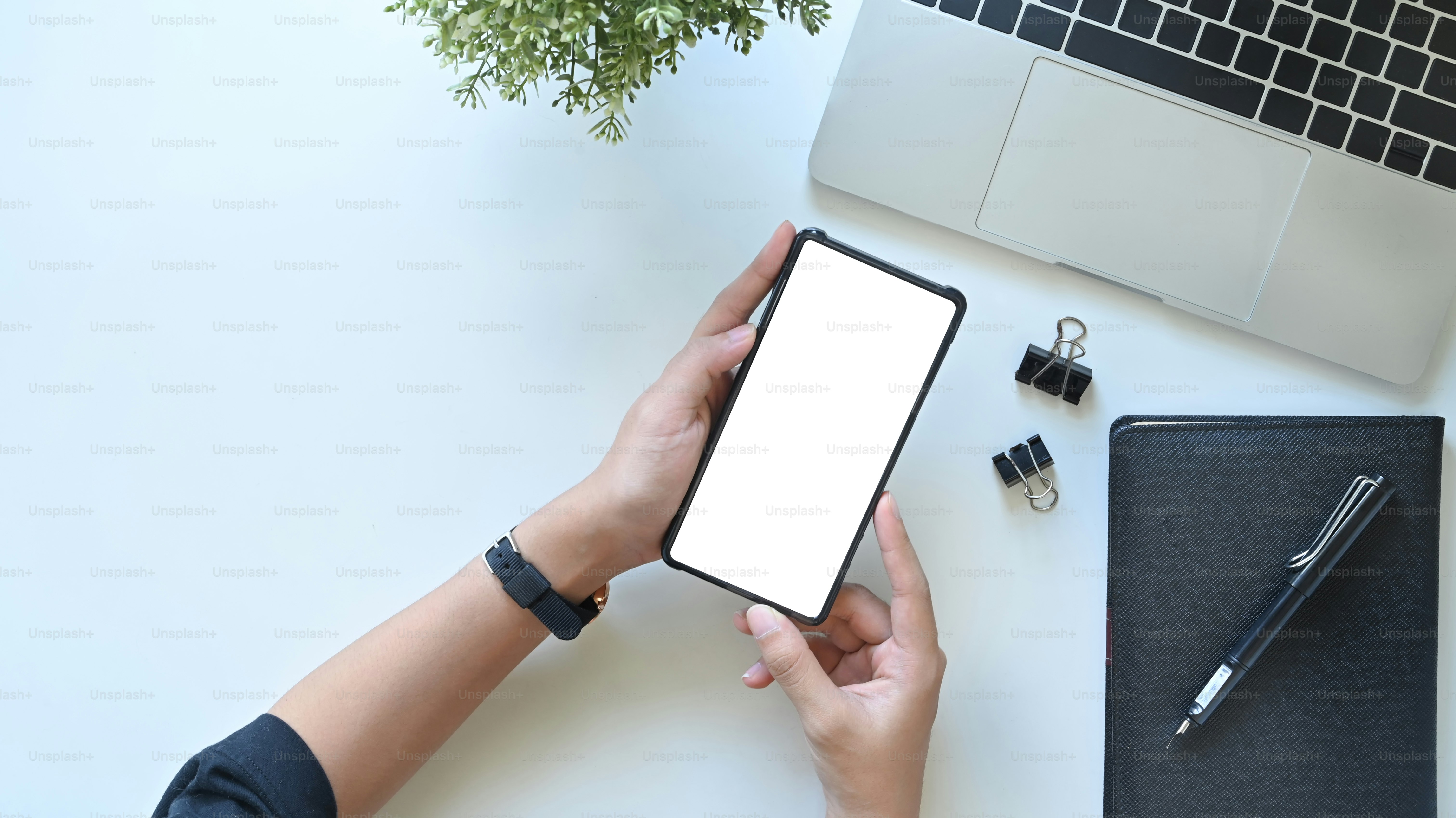 Woman using mobile phone at office white desk table with desktop ...