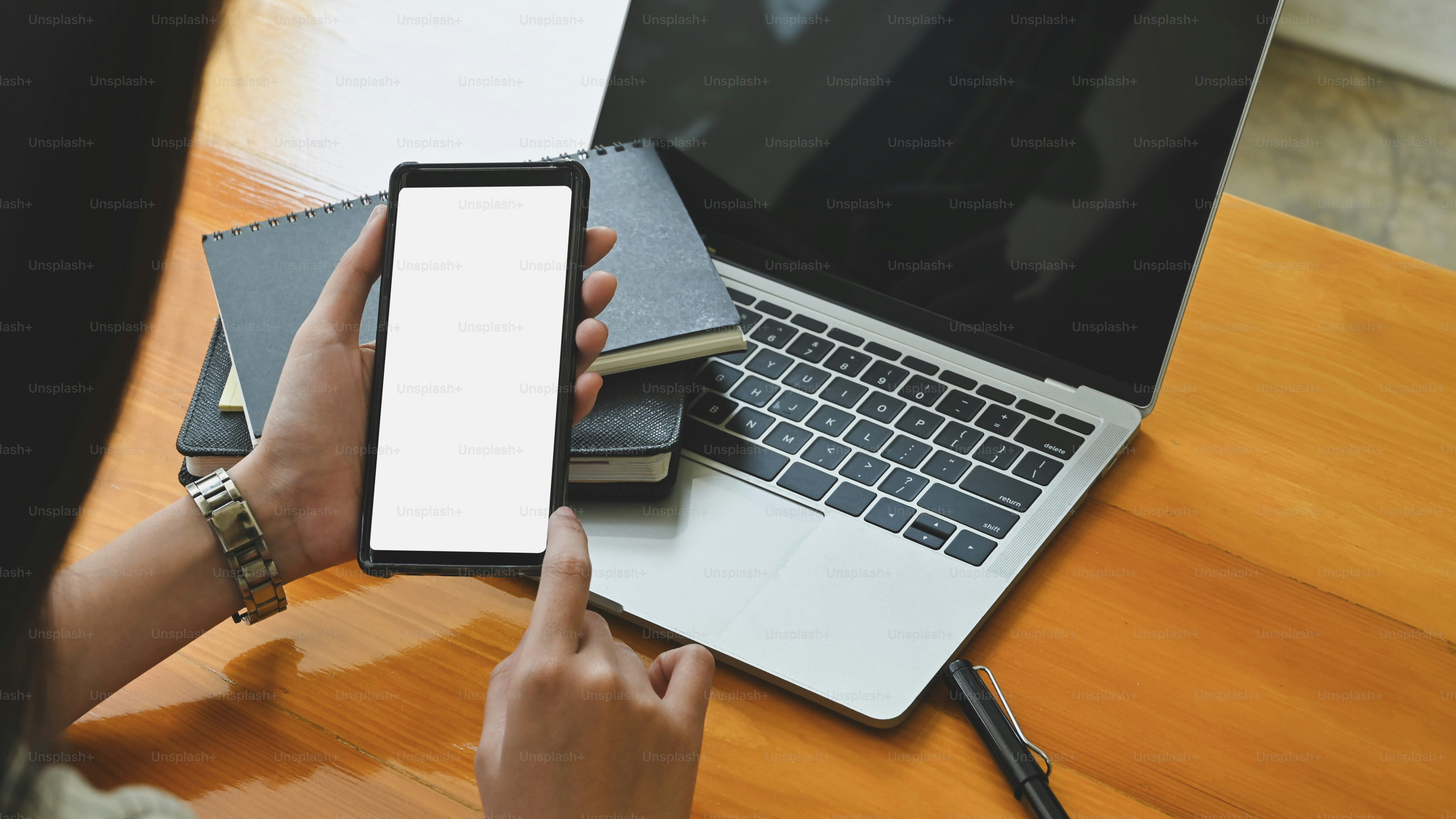 Top view woman using mockup smartphone with isolated white screen ...